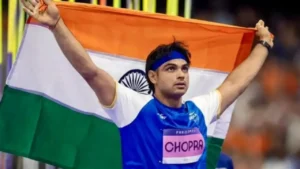 Neeraj Chopra celebrates after breaking the 90m javelin throw record at Doha Diamond League 2025 with Indian flag